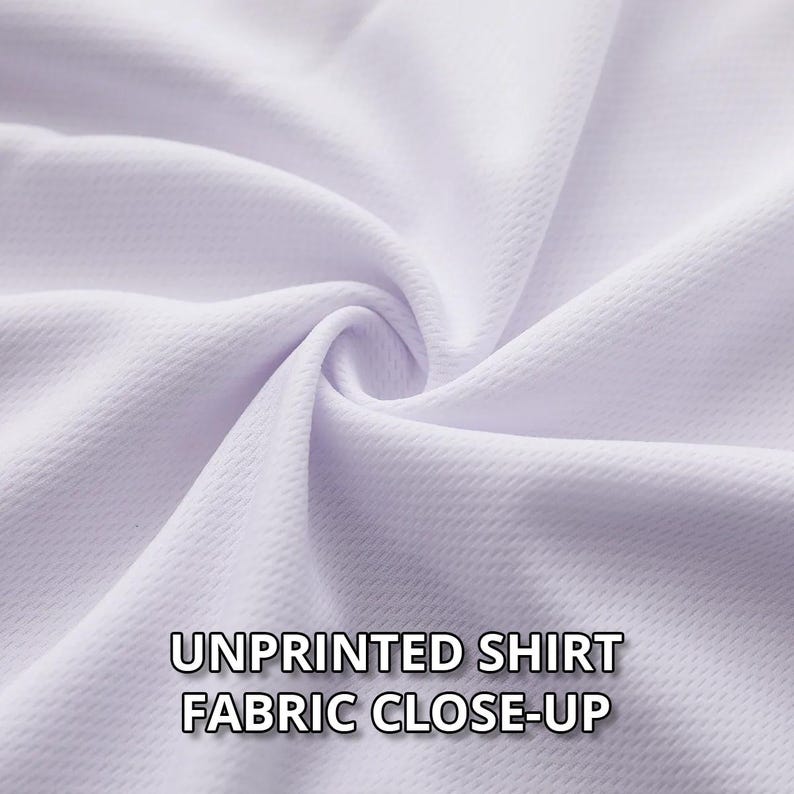 May include: Close-up of white unprinted shirt fabric. The fabric is tightly woven with a textured surface, and the image highlights the folds and subtle variations in the material. The text "UNPRINTED SHIRT FABRIC CLOSE-UP" is displayed at the bottom.