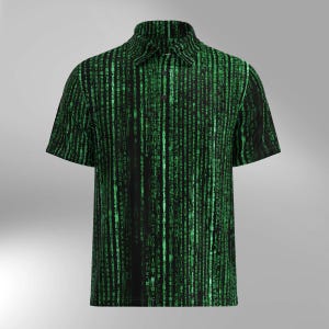 May include: Short-sleeved polo shirt featuring a black backdrop and a green digital rain design. The shirt has a collared neckline and a button-down front. The pattern is inspired by the Matrix film.