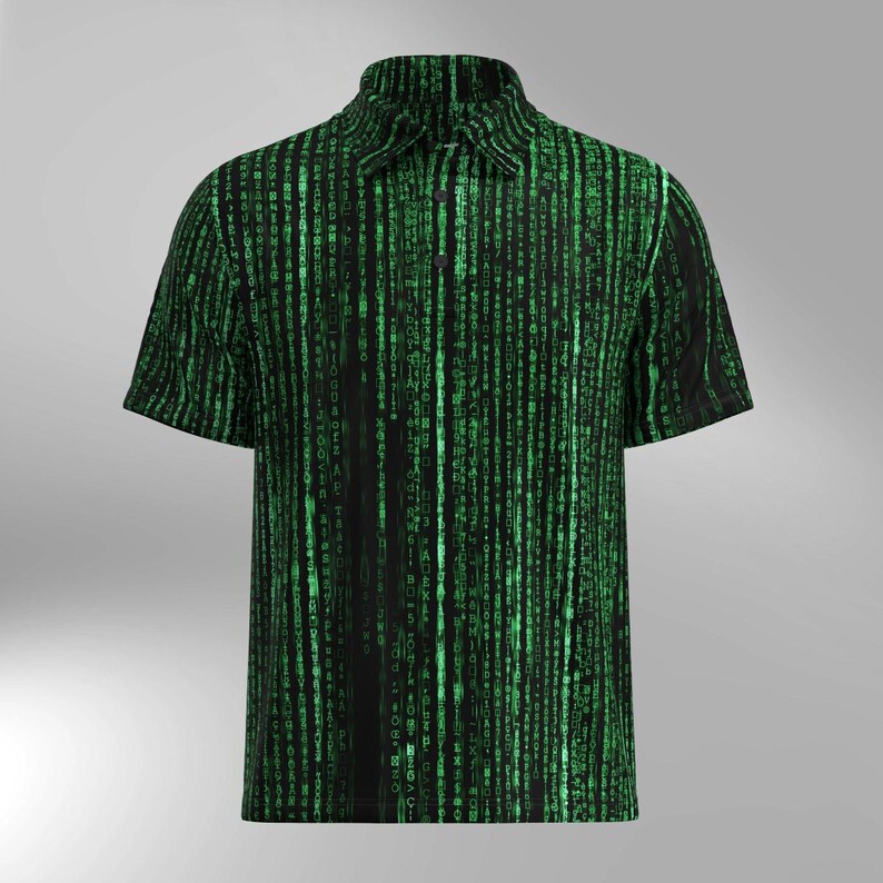 May include: Short-sleeved polo shirt featuring a black backdrop and a green digital rain design. The shirt has a collared neckline and a button-down front. The pattern is inspired by the Matrix film.