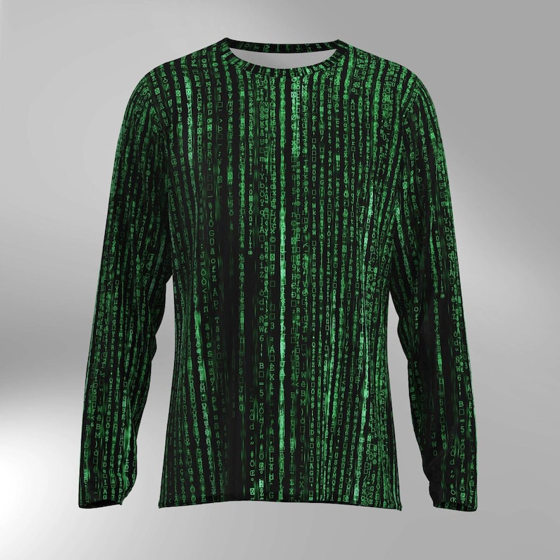 May include: Black long-sleeved shirt with a green digital rain pattern. The design features vertical lines of green characters on a black background, creating a tech-inspired aesthetic. The shirt has a crew neck and long sleeves, suitable for casual wear.