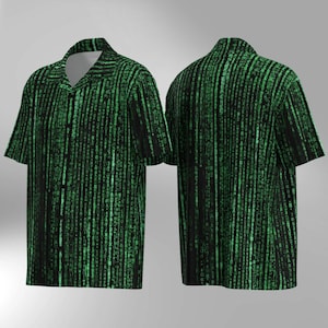 May include: Short-sleeved button-down shirt with a black background and a green, vertical, digital rain pattern. The shirt has a classic collar and a relaxed fit, suitable for casual wear. The design is reminiscent of computer code.