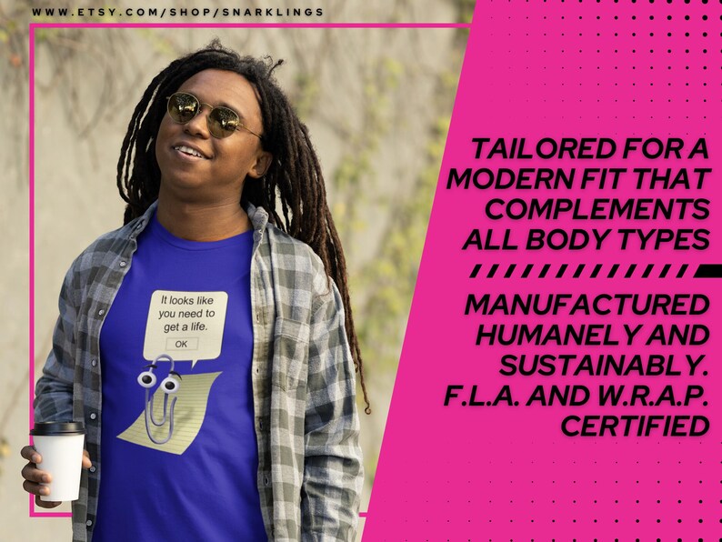 May include: A blue t-shirt with a white paperclip graphic and the text "It looks like you need to get a life. OK." The shirt is being worn by a person with long dreadlocks and a plaid shirt. The background is a blurred image of trees and foliage. The text "TAILORED FOR A MODERN FIT THAT COMPLEMENTS ALL BODY TYPES MANUFACTURED HUMANELY AND SUSTAINABLY. F.L.A. AND W.R.A.P. CERTIFIED" is in white text on a pink background.