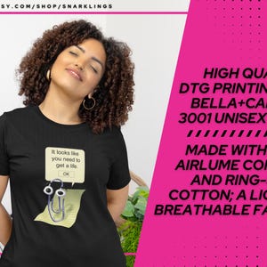May include: Black unisex t-shirt with the text "It looks like you need to get a life. OK" and a cartoon image of a paperclip. High quality DTG printing on Bella + Canvas 3001 unisex tees. Made with 100% airlume combed and ring-spun cotton; a light and breathable fabric.