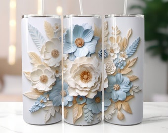 May include: A white tumbler featuring a blue and white floral design. The flowers are 3D and have a paper-like texture.