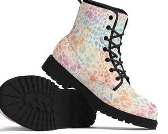 May include: A pair of colorful ankle boots with a pastel pattern. The boots have a cream-colored base with a pattern of pink, blue, and orange spots. They feature black laces, a black sole, and a black heel.