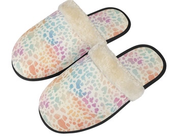 May include: A pair of colorful, patterned slippers. The slippers feature a soft, plush interior and a vibrant design with pastel hues of pink, blue, yellow, and orange. The outer sole is black.