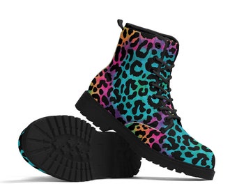 May include: A pair of black combat boots with a vibrant leopard print in shades of pink, orange, blue, and green. The boots have black laces and soles, and are set against a white background.