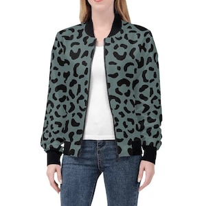 May include: A green bomber jacket with a black leopard print pattern. The jacket has a zip closure and ribbed cuffs and waistband.