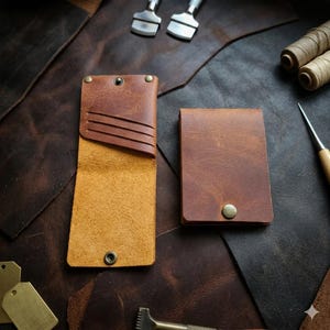 May include: A set of three ceramic vases in varying heights. The vases are white with a textured, ribbed design. The tallest vase is approximately 10 inches tall, the medium vase is 8 inches, and the smallest is 6 inches.