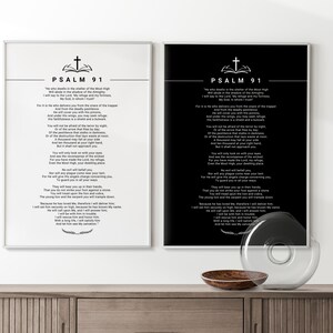 May include: Two black and white framed prints of Psalm 91, a biblical passage, with a cross and an open book at the top. The text is in black and white and the background is white on the left print and black on the right print.