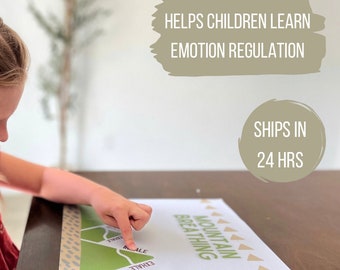 May include: A child's hand points to a green and brown printable chart with the words "Mountain Breathing" and "Exhale" and "Inhale" on it. The chart is on a wooden table.