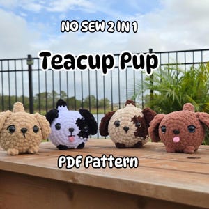 May include: Four crocheted teacup pup amigurumi toys in different colors. The toys are sitting on a wooden table. The text "NO SEW 2 IN 1 Teacup Pup PDF Pattern" is displayed above the toys.