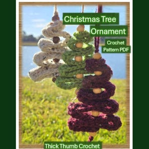 May include: Three handmade crochet Christmas tree ornaments in cream, green, and burgundy. Each tree has a spiral design and wooden bead accents. The image includes text that reads "Christmas Tree Ornament Crochet Pattern PDF" and "Thick Thumb Crochet."