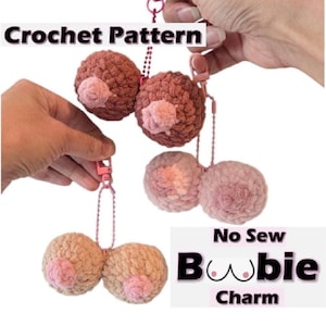 May include: Crochet pattern for a boobie charm. The image shows multiple crocheted breast-shaped charms in various shades of brown and pink, each with a pink nipple. The charms are attached to keychains.