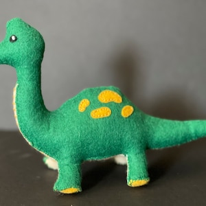 Felt dinosaur baby toy with rattle