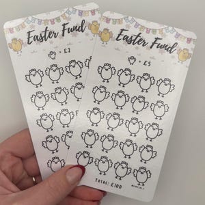May include: Two white cards with the text "Easter Fund" and illustrations of chicks. One card has "= £2" and the other has "= £5". The cards have a banner of bunnies and chicks at the top. The total amount is £100.