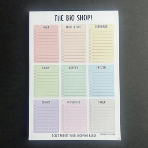 May include: A shopping list notepad with the text "THE BIG SHOP!" and sections for meat, fruit & veg, cupboard, dairy, bakery, frozen, drinks, household, and other. The notepad also includes the text "DON'T FORGET YOUR SHOPPING BAGS!"