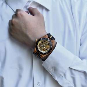 automatic wristwatch worn by man