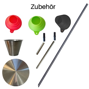 May include: A set of kitchen tools including a red, green, and black silicone funnel, a stainless steel measuring cup, a stainless steel lid, two metal rods, and a long metal rod. The text "Zubehör" is written in black at the top of the image.
