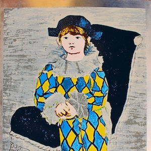 May include: A colorful print of a child dressed as a jester, sitting in a chair. The child is wearing a blue and yellow diamond patterned costume with a white ruffle collar. The print is signed in the bottom right corner.