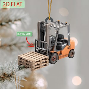 May include: An orange and black forklift ornament with a wooden pallet. The ornament has the text "Your Name" and "Custom Name". The ornament is 2D flat and has a gold string for hanging.