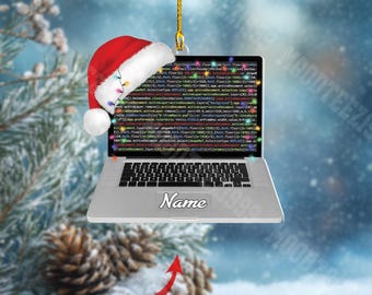 May include: A silver laptop Christmas ornament with a Santa hat, displaying code on the screen. The ornament has a gold string for hanging and includes the text "Name" and "CUSTOM NAME".