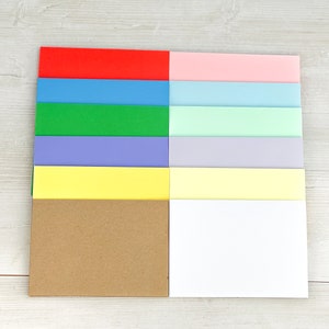 12 blank cards in these colours: vibrant red, blue, green, purple, yellow, pastel pink, blue, green, purple, yellow, white and kraft brown
