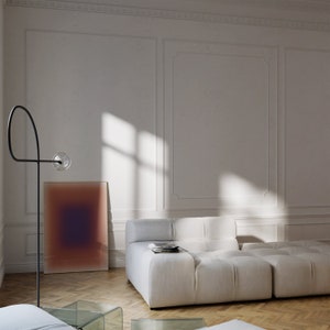 May include: A white modular sofa with a textured fabric, positioned in a room with white walls and a large abstract painting on the wall. The sofa is made up of multiple individual pieces that can be arranged in different configurations.