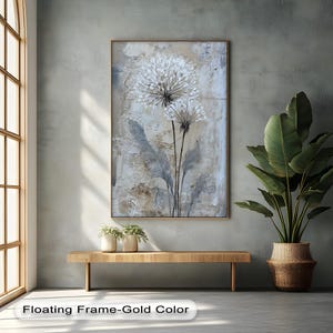 a large painting of a flower hanging on a wall, with a wooden bench below it and a potted plant to the right. The painting has a floating frame-gold color.