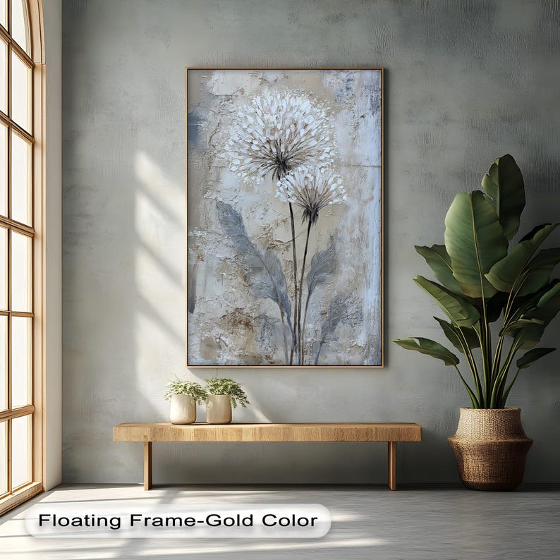 a large painting of a flower hanging on a wall, with a wooden bench below it and a potted plant to the right. The painting has a floating frame-gold color.