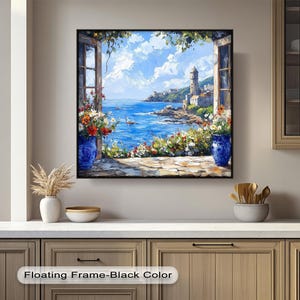 May include: A framed painting of a coastal scene seen through an open window. The artwork features a bright blue sea, a lighthouse, and a village. Colourful flowers in blue vases frame the window, with the text "Floating Frame-Black Color" at the bottom.