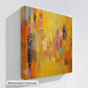 May include: A stretched canvas abstract painting with a textured surface. The artwork features a vibrant palette of yellow, orange, purple, and teal brushstrokes. The painting has a modern, contemporary style and is displayed on a white wall.