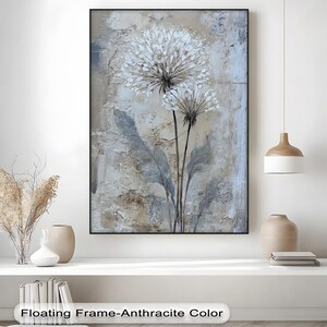 a large painting of a flower with a floating frame-anthrachtite color, hanging on a wall above a white shelf with various decorative items.