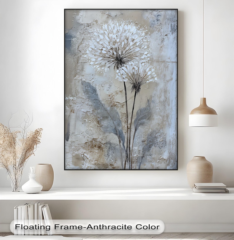 a large painting of a flower with a floating frame-anthrachtite color, hanging on a wall above a white shelf with various decorative items.