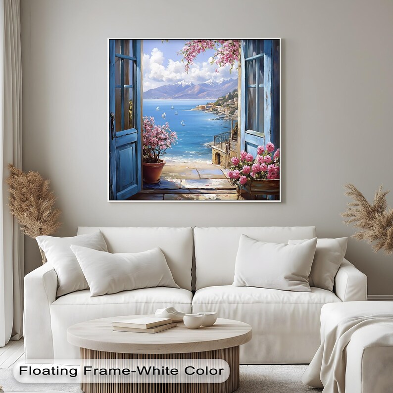 a living room with a white couch and a painting on the wall