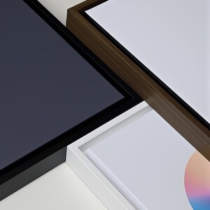 three distinct artworks, each with a unique color scheme and frame style, arranged in a visually appealing manner.