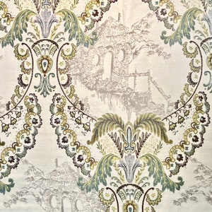 May include: Beige fabric with a repeating pattern of green, brown, and purple floral designs. The pattern also includes a faded image of a small house with a thatched roof.