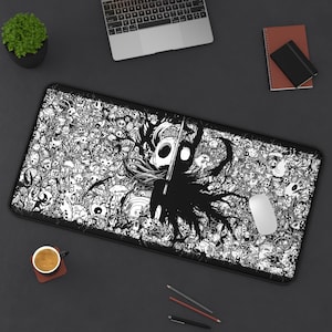 May include: Black and white gaming mousepad featuring a detailed illustration of a character with a sword, surrounded by a multitude of skulls and creatures. The mousepad is rectangular and includes a white mouse.