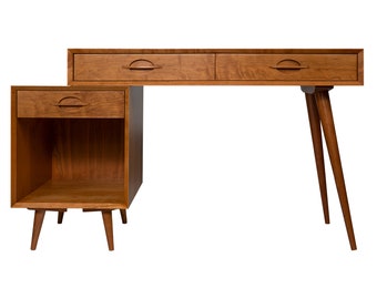May include: A mid-century modern desk with two drawers and a side cabinet. The desk is made of wood and has tapered legs. The desk is brown in color.