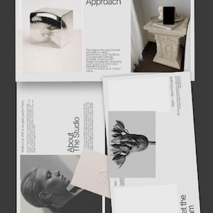 May include: A grayscale image featuring design elements. It includes a silver cube, a black smartphone on a pedestal, and various printed materials. Text on the materials reads "Our Vision & Approach," "About The Studio," and "Meet the Team."