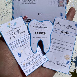 May include: A collection of Tooth Fairy items, including a letter, certificate, and receipt. The certificate is awarded to Oliver for losing a tooth. The receipt shows a payment of $10. The items are decorated with fairy and tooth graphics.