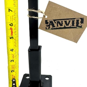May include: Black metal stand with a square base and four holes. The stand is 6 inches tall and has a label that says "ANVIL".