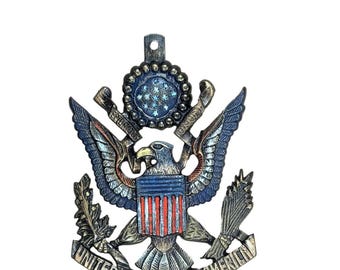 Cast iron American Eagle USA sign with a flag design featuring military themes in red, white, and blue.