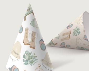 May include: Two party hats with a travel-themed pattern. The hats are cone-shaped, one upright and the other partially unrolled. The pattern includes boots, compasses, hats, and tropical leaves in muted colors.