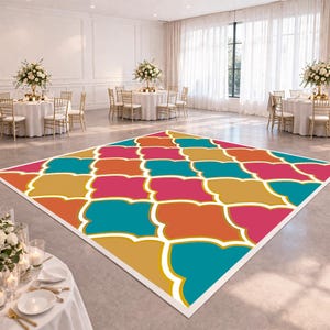 May include: A colorful dance floor with a geometric pattern in shades of teal, orange, pink, and gold. The floor is set in a large event space with round tables, chairs, and floral centerpieces. The floor is a focal point.