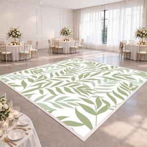 May include: A large, rectangular dance floor with a white background and a repeating pattern of green leaves. The floor is set up in a large, well-lit event space with round tables, chairs, and floral centerpieces. The floor measures approximately 12 feet by 12 feet.