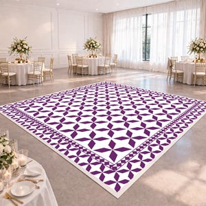 May include: A large, square dance floor with a white background and a repeating pattern of purple geometric shapes. The floor is surrounded by a decorative border and is set up in a large event space with round tables and floral centerpieces.