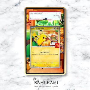 May include: A framed Pok&eacute;mon trading card featuring Pikachu with a burger and drink. The card has Japanese text and a McDonald's logo. The frame is gold-colored, and the card is graded as GEM MINT 10.