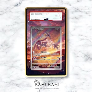 May include: A framed Pok&eacute;mon trading card featuring a pink and white creature with the text "艾姆利多". The card is encased in a gold-colored frame with a black border. The frame has a "GEM M 10" label. The background shows a sunset.