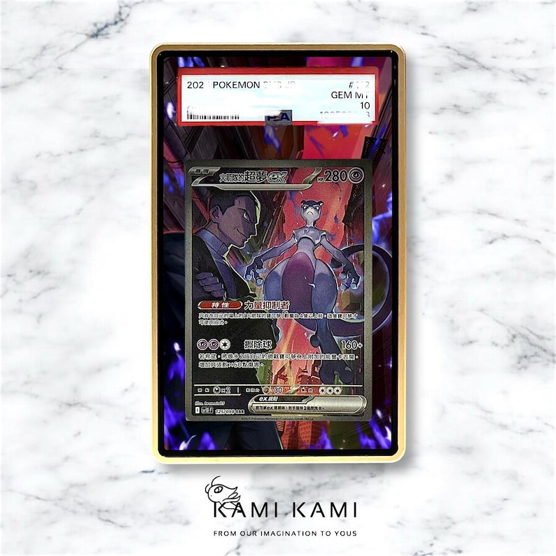 May include: A graded Pok&eacute;mon card featuring Mewtwo and a character in a suit. The card is encased in a gold-colored frame. The card has Japanese text and a GEM M 10 grade.